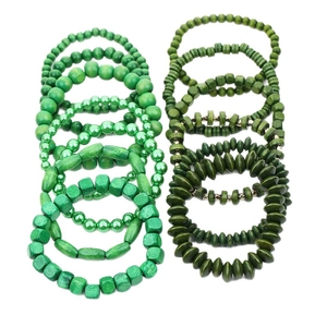 Set of 13 green wooden bead bracelets with various round and oval shapes on white background