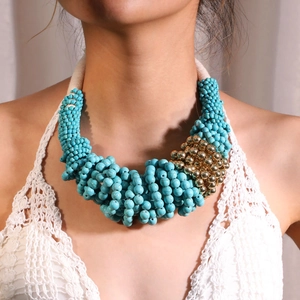 Close-up of Bohemian layered necklace featuring blue beads on white cotton rope