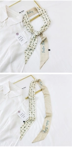 Detail of beige skinny scarf featuring green avocado print and Positive Thinking lettering