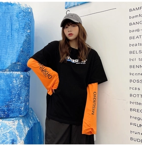 Detail of street-style faux two-piece sunscreen sleeves in black and orange contrast