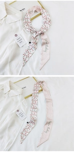 Detail of pink floral narrow scarf with positive thinking text for hair or bag