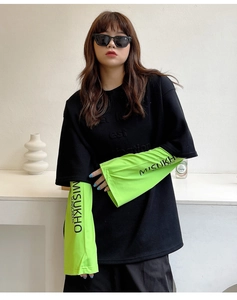 Close-up of black and neon green sun protection sleeves with street style printed text