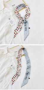 Detailed view of floral silk twilly scarf with Positive Thinking slogan and watermelon print