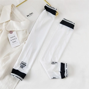 Detail of white cooling sun protection sleeves with thumb holes and contrast lettering