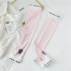Close-up of pink and white ice silk sun sleeves with thumb hole and elastic lettering band