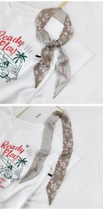 Detailansicht des Twilly-Schals mit Blumenmuster, Punkten und Love Yourself-Schriftzug