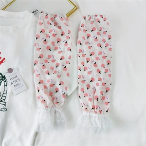 Detail of white long arm sleeves featuring peach floral patterns and double lace cuffs