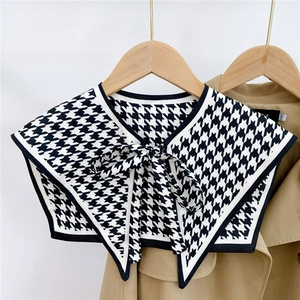 Close-up of houndstooth decorative fake collar with a stylish black bow tie detail
