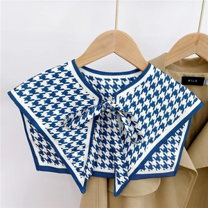 Detail of blue houndstooth fake collar with adjustable tie bow on khaki jacket