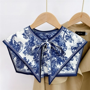 Close-up of Toile de Jouy print scarf collar with elegant blue and white tie ribbon