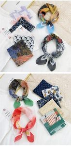 Detailed close-up of printed cotton-linen square scarves with floral and fruit patterns
