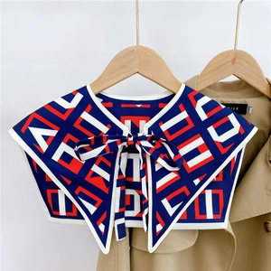 Detail of geometric pattern faux collar with bow tie on khaki trench coat