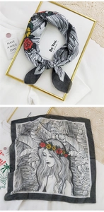 Detail of cotton linen scarf featuring floral portrait print and tropical leaf patterns