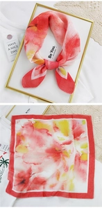 Detail of square cotton linen scarf featuring vibrant watercolor floral prints and fine edges