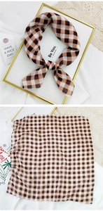 Close-up of a brown and black checkered cotton linen scarf with clean stitched edges