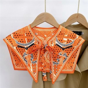 Close-up of vintage orange equestrian print decorative faux collar with a front bow tie knot