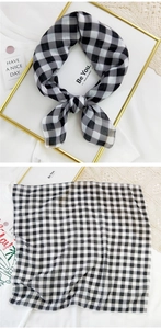 Detailed view of lightweight black and white checkered cotton linen scarf with fine hem edges