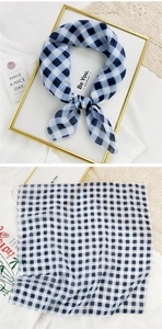 Close-up of blue and white checkered cotton linen scarf with soft texture and neat edges