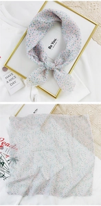 Close-up of pink floral linen scarf tied in a bow with detailed texture and pattern