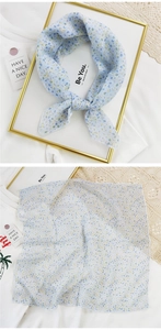 Detail of light blue floral cotton linen square scarf with yellow flower patterns