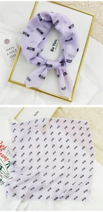 Detail of lavender cotton linen square scarf featuring stylish black Chinese character print
