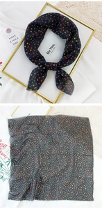 Detail of black cotton linen scarf with colorful geometric patterns and fine stitching