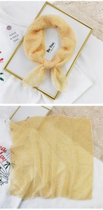 Detail of yellow cotton linen scarf with colorful polka dots and lightweight fabric texture