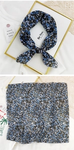 Close-up of blue floral cotton linen scarf with fine edge stitching and soft texture