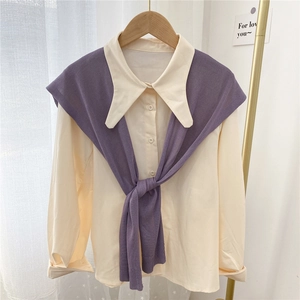 Chic cream blouse with purple knitted shawl draped over shoulders for a stylish layer