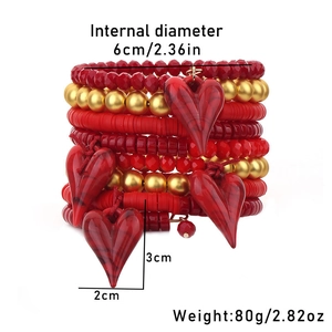 Detail view of multi-layer red beaded bracelet with heart charms and product dimensions