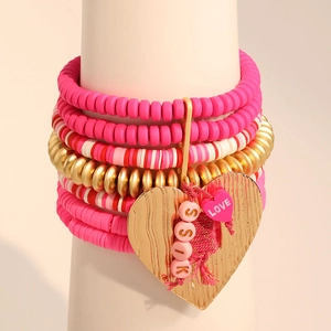 Bohemian multi-layer pink clay bead bracelet set with a large gold heart charm