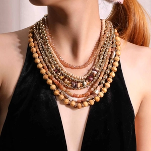 Bohemian multilayer necklace with natural stone, wood beads, and gold accents worn on a model