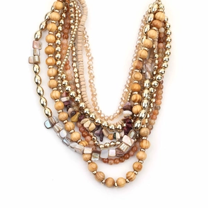 Bohemian multilayer necklace with natural stone, wood beads and shell accents on white background