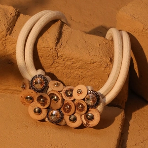 Bohemian double-layer coconut wood necklace with crystals on rustic stone background