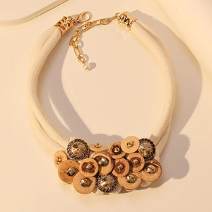 Detail of bohemian choker featuring coconut wood discs and crystal on woven rope