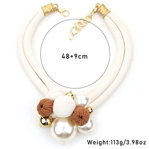 Detail of elegant double-layered pearl necklace with large beads and white woven rope