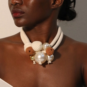 Chunky double-layer necklace with cream rope, large pearls and fabric beads on model