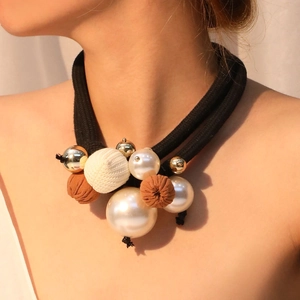 Detail of double-layer choker featuring imitation pearls, gold spheres and woven accents