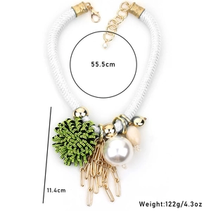 Macro detail of faux pearl flower tassel necklace with dimensions and weight specs
