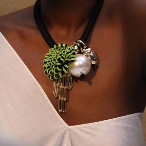 Floral fringe necklace with neon green flower and large pearl on a black cord