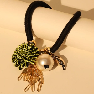 Artistic flower necklace with black rope cord, large faux pearl, and gold metal links