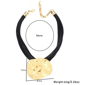 Detailed view of bohemian wax cord necklace with large hammered metal disc pendant dimensions