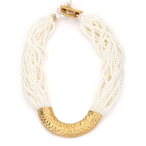 Detail of multi-strand pearl necklace with textured gold U-shaped pendant and T-bar clasp