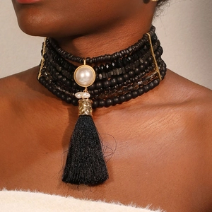 Multilayer black beaded choker necklace with pearl pendant and silk tassel detail