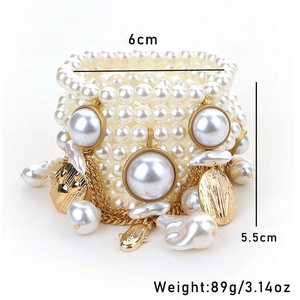 Detailed view of multilayer pearl bracelet with gold charms, 6cm width and 5.5cm height