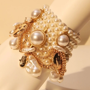 Elegant multi-layer pearl tassel bracelet with gold chains and vintage pendants
