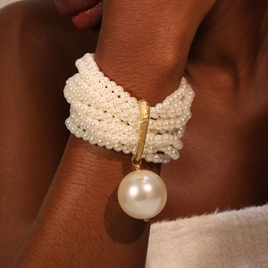 Elegant multilayer beaded pearl bracelet with gold hardware and large pearl drop charm