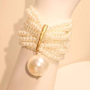 Multi-layer beaded pearl bracelet featuring gold textured bar and large pearl pendant
