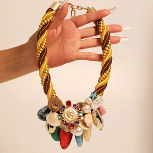Bohemian woven rope necklace with shells, starfish charms, and a gold coin pendant