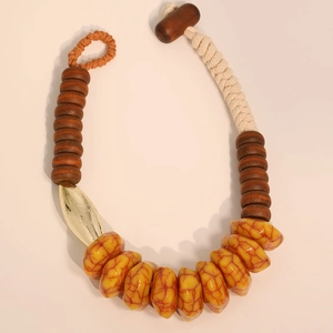 Détail de collier fait main avec perles en acrylique, bois et résine de style bohème